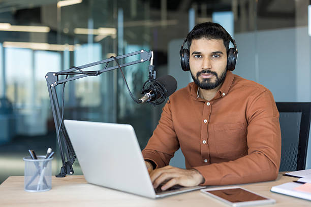 istock Young man creating podcast content with laptop and microphone 2248726317
