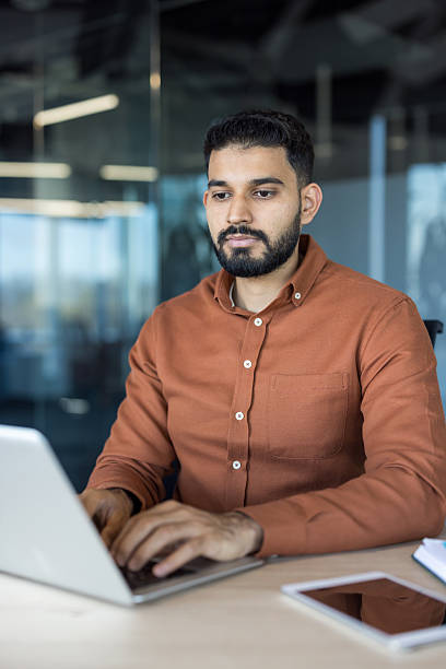 istock Indian businessman working on laptop in modern office 2248727049
