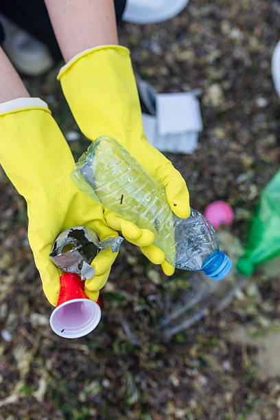 istock volunteer cleaning polluted beach, collecting 2248727103