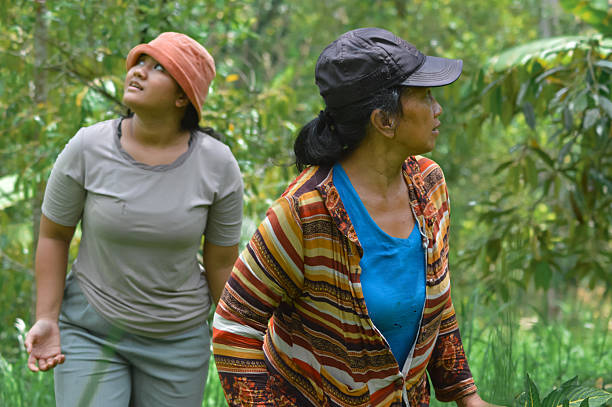 istock Mother Observing Field While Daughter Looks Upward in Agroforestry Field 2248730178