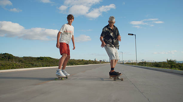 A Senior Man Skateboarding with his Grandson