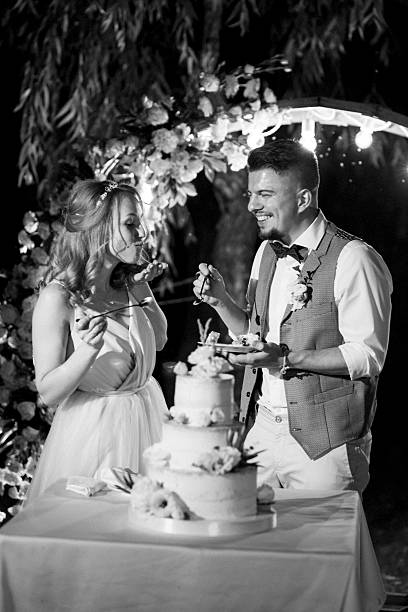 istock newlyweds happily cut and taste the wedding cake 2248731789
