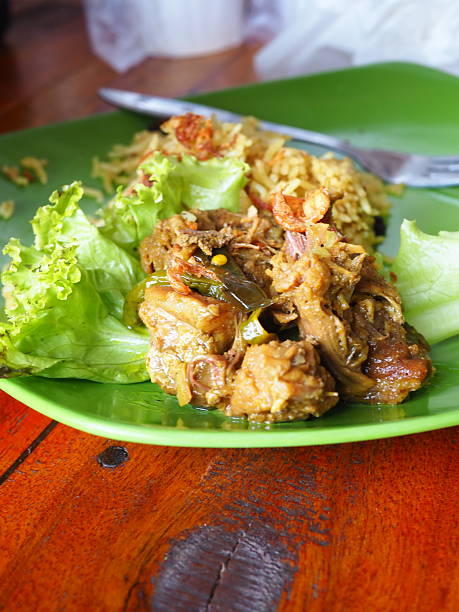 istock Overhead shot shows a delectable chicken dish with rice, and lettuce on a vibrant green plate. 2248731866