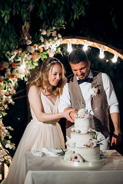 istock newlyweds happily cut and taste the wedding cake 2248732422