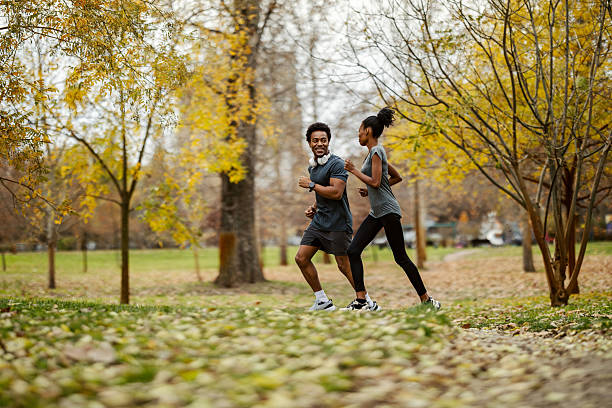 istock Couple jogging in park during autumn season 2248733351