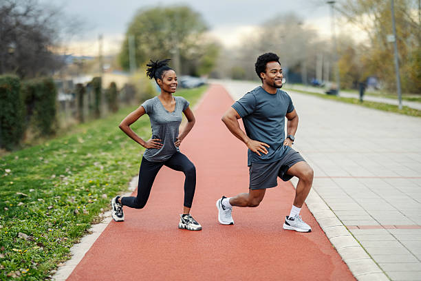istock Couple doing lunges on running track outdoors 2248733534