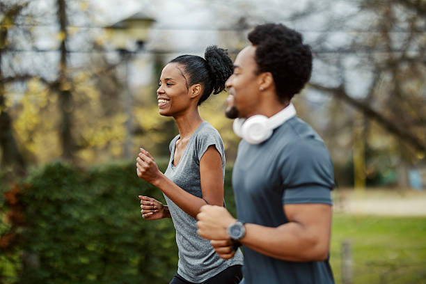 istock Happy couple jogging together in park 2248733557
