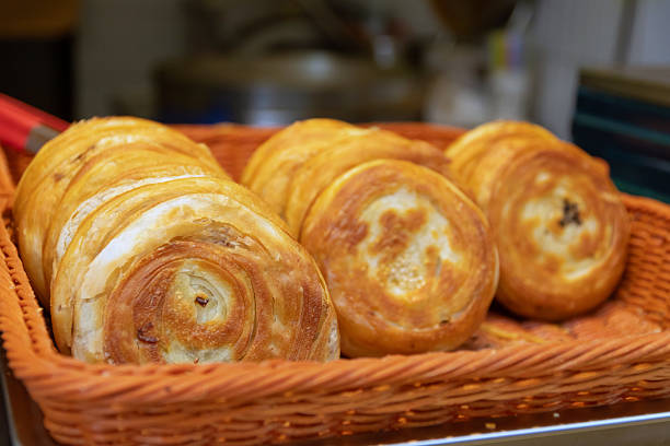 A Guo Kui, Crispy stuffed flatbread is truly scrumptious with flaky and crispy layers on the outside and a flavorful and delicious filling on the inside. Chengdu street food, China.