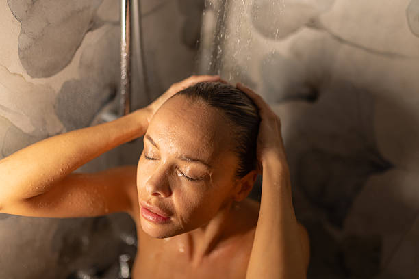 istock Beautiful woman taking a shower 2248734243