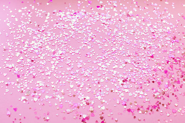 istock Abstract background of pink heart-shaped sparkles. 2248734250