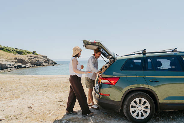 istock Smiling couple on the summer vacation by car 2248735256