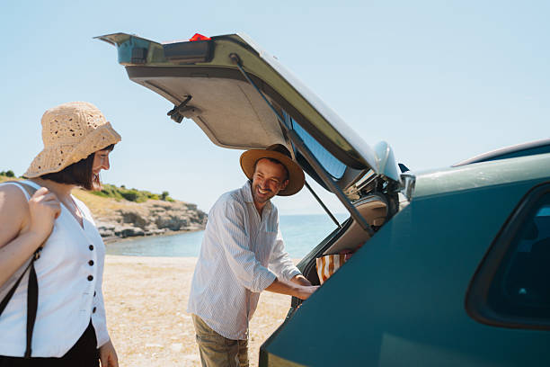 istock Smiling couple on the summer vacation by car 2248735260