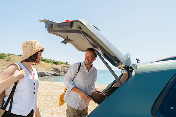 istock Smiling couple on the summer vacation by car 2248735270