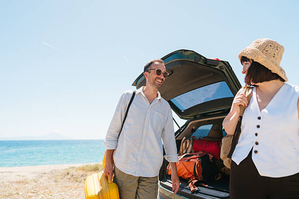 istock Smiling couple on the summer vacation by car 2248735277