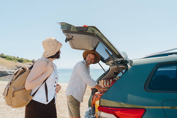istock Smiling couple on the summer vacation by car 2248735285