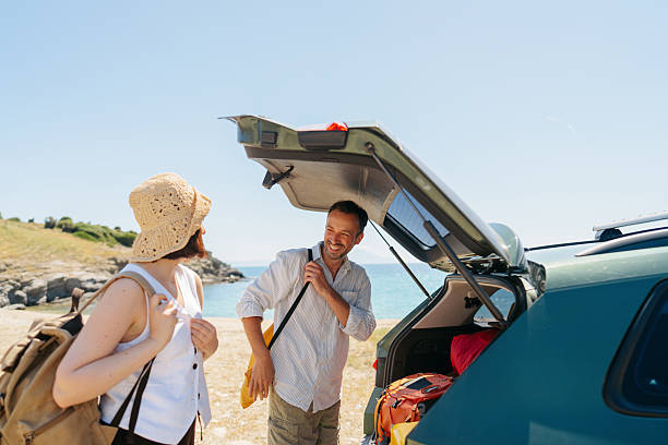 istock Smiling couple on the summer vacation by car 2248735328