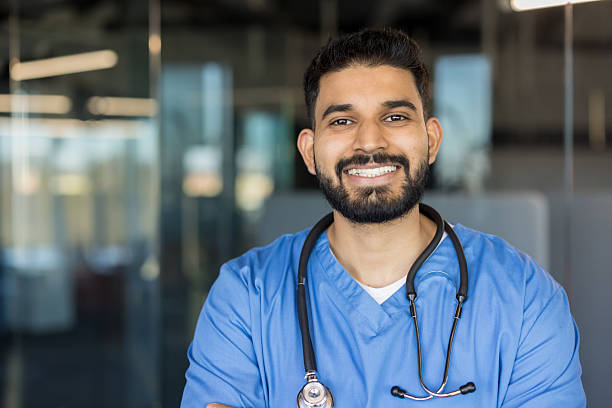 istock Young man doctor smiling wearing blue scrubs and stethoscope 2248736014