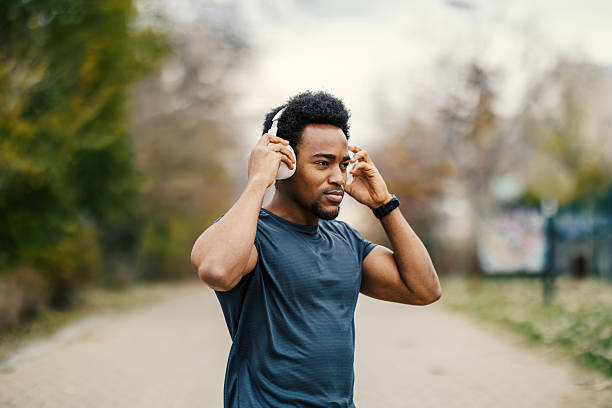 istock Young man adjusting headphones for outdoor workout 2248736333