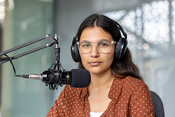 istock Young woman podcast host recording audio content 2248736571