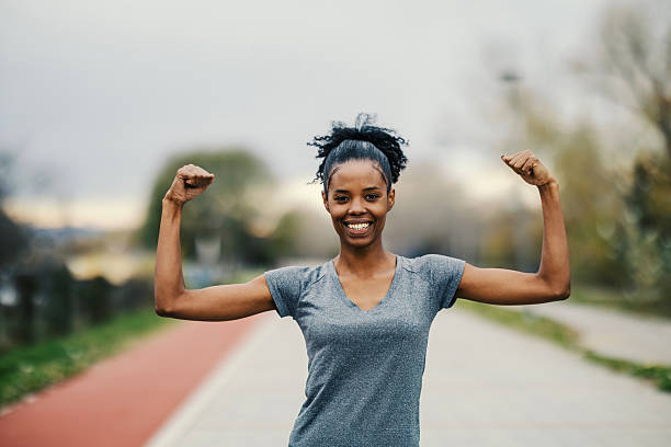 istock Strong athletic woman flexing biceps on running track 2248736624