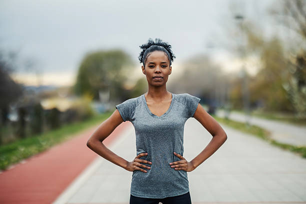 istock Young woman standing on running track feeling confident and strong 2248736647