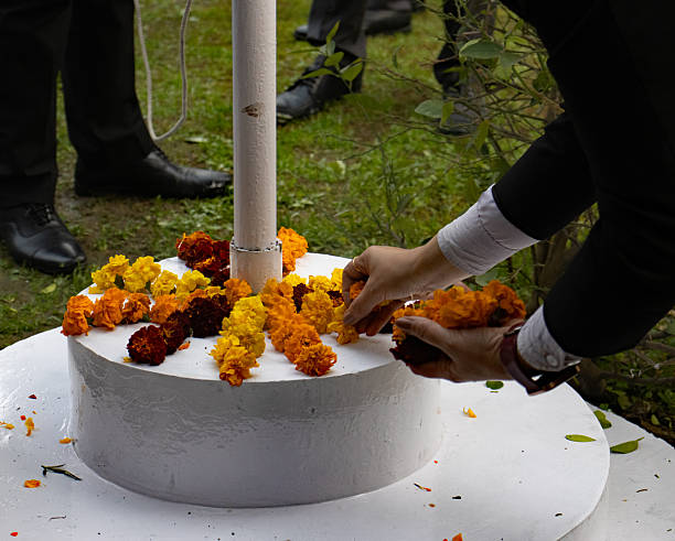 hands placing flowers on a white platform for India Day