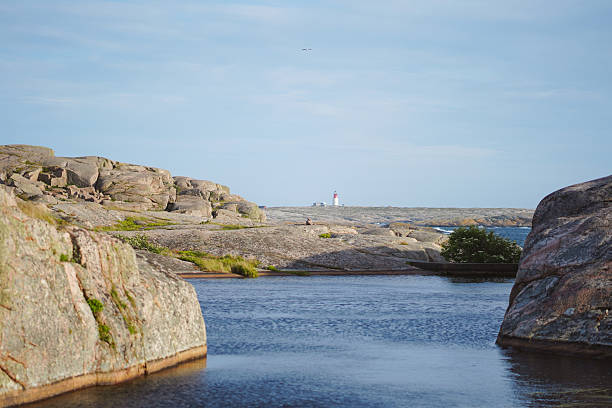 Distant view of lighthouse on rocky coastline