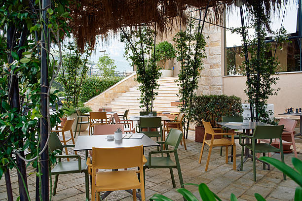 Inviting Outdoor Dining Area Featuring Colorful Chairs and Tables Surrounded by Lush Greenery in a Cozy Ambiance Perfect for Relaxation