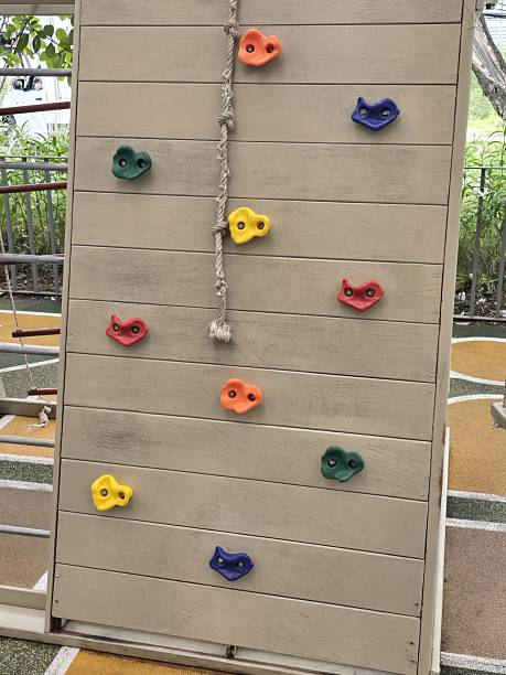 istock Colorful climbing wall with holds for children's play area fun 2248740643