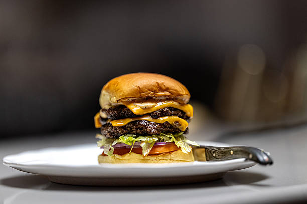 istock Gourmet double cheeseburger with melting cheese on a plate 2248740746