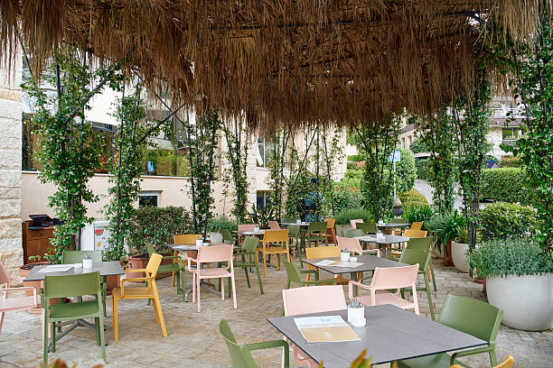 istock Charming Outdoor Dining Area Surrounded by Lush Greenery and Rustic Decor Perfect for Relaxing Meals and Social Gatherings in a Tranquil Setting 2248741177