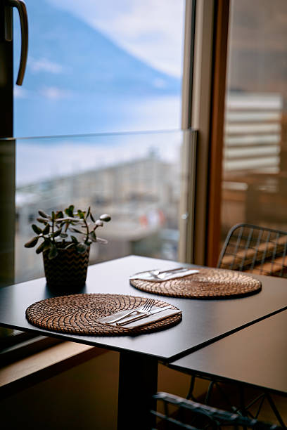 istock A Cozy Dining Space Featuring Elegant Table Settings Overlooking a Scenic View with Natural Light and Decorative Plant Enhancing the Ambiance 2248741698