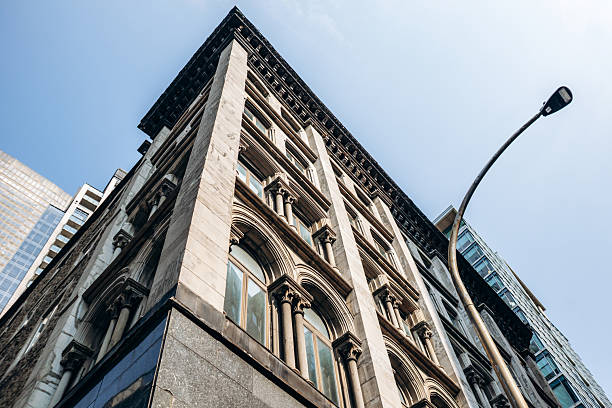 istock Historic downtown building facade with detailed stone architecture and large arched windows in central Montreal 2248742132