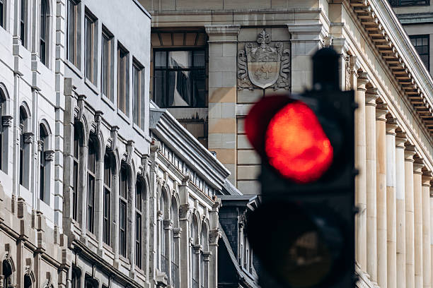 istock Downtown historic building facade with arched windows and red traffic light in foreground 2248742207
