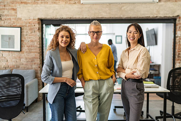 istock Diverse businesswomen team standing smiling in modern office 2248743119