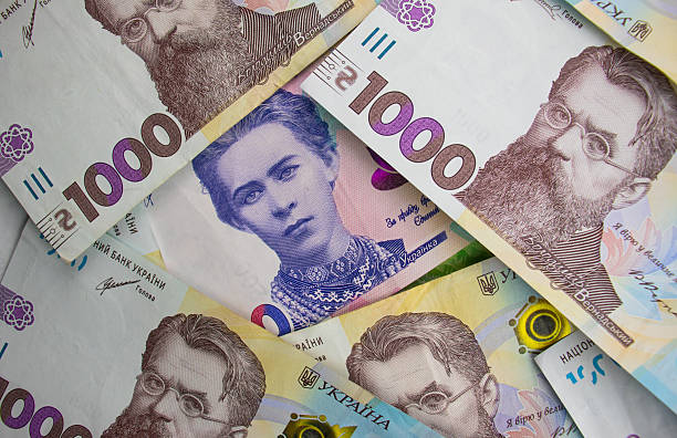istock Multiple Ukrainian banknotes showing different denominations and historical figures on a colorful surface 2248743776