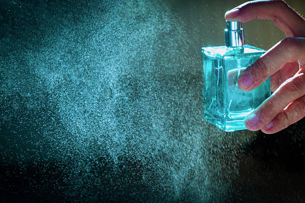 istock A hand holds a bottle of perfume spraying the liquid into a fine diffusion in hard light 2248745023