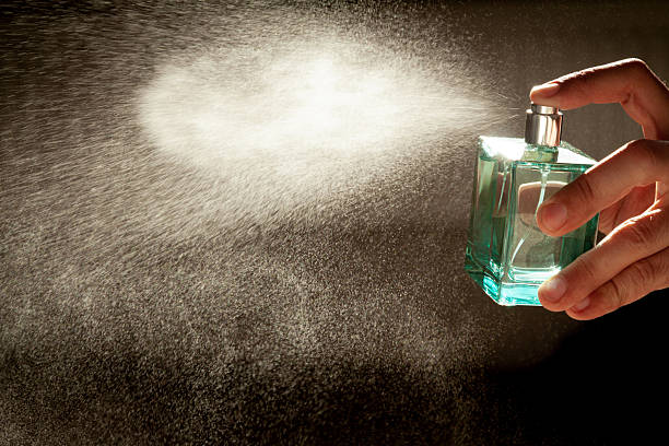 istock A hand holds a bottle of perfume spraying the liquid into a fine diffusion in the beautiful sunset light 2248745042