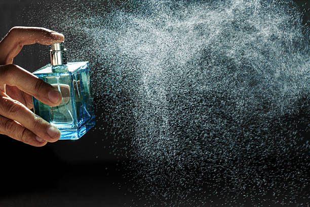 istock A hand holds a bottle of perfume spraying the liquid into a fine diffusion in hard light 2248745043