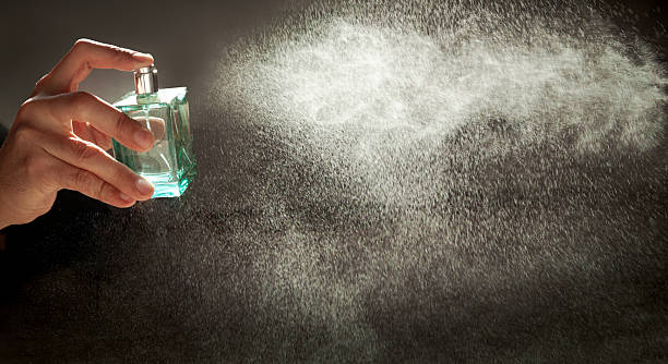 istock A hand holds a bottle of perfume spraying the liquid into a fine diffusion in the beautiful sunset light 2248745044