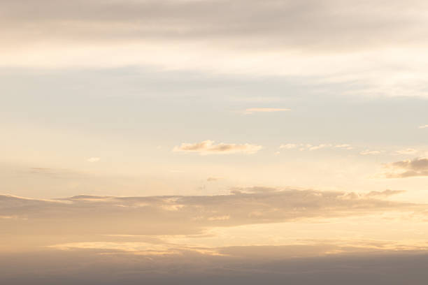 A tranquil sunset scene featuring warm golden clouds and a serene blue sky, perfect for calm, contemplative moods.