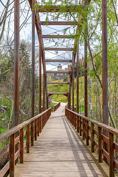 istock Wooded Park Walkway Points To Historic Tower 2248747557