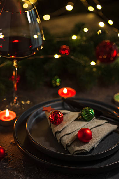 istock Christmas Table Setting with Tree-Shaped Napkin, Utensils, Ornaments and Tealight Candles 2248749626