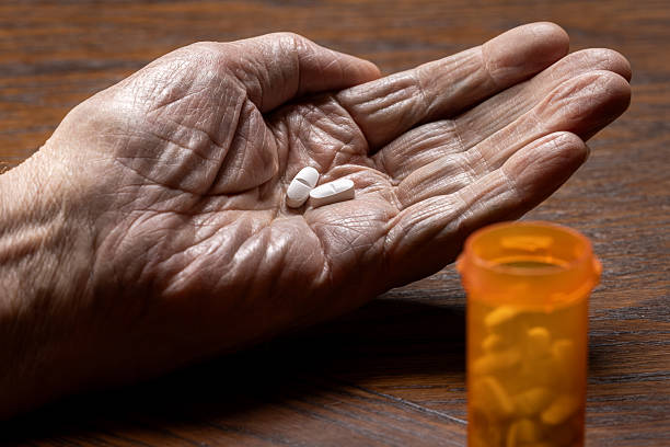 istock Close-Up of Elderly Hand Dosing Pills 2248754199