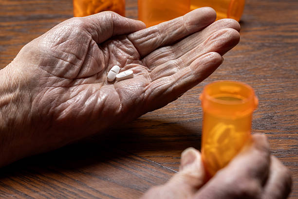 istock Close-Up of Elderly Hand Dosing Pills 2248754337