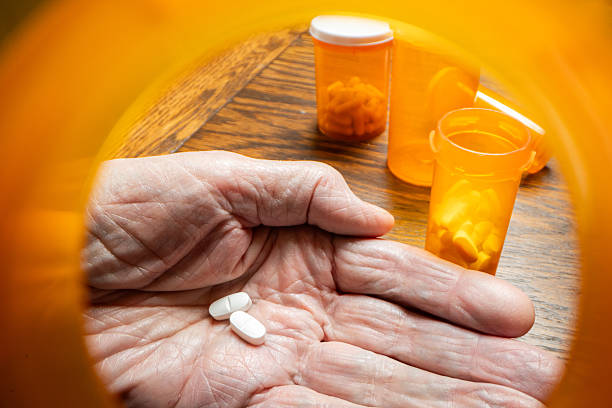 istock POV from Pill Bottle into Elderly Hand 2248755647