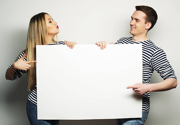 istock Couple holding a banner 2248755875