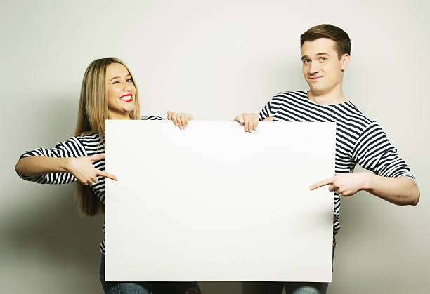 istock Couple holding a banner 2248755971