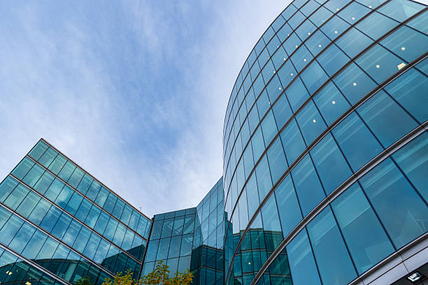 istock Modern Curved Glass Office Building Facade against Blue Sky. 2248758561