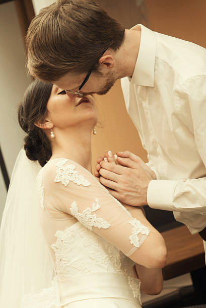 stylish luxury  bride and elegant groom, hugging with tenderness,on the background of the old city Lviv